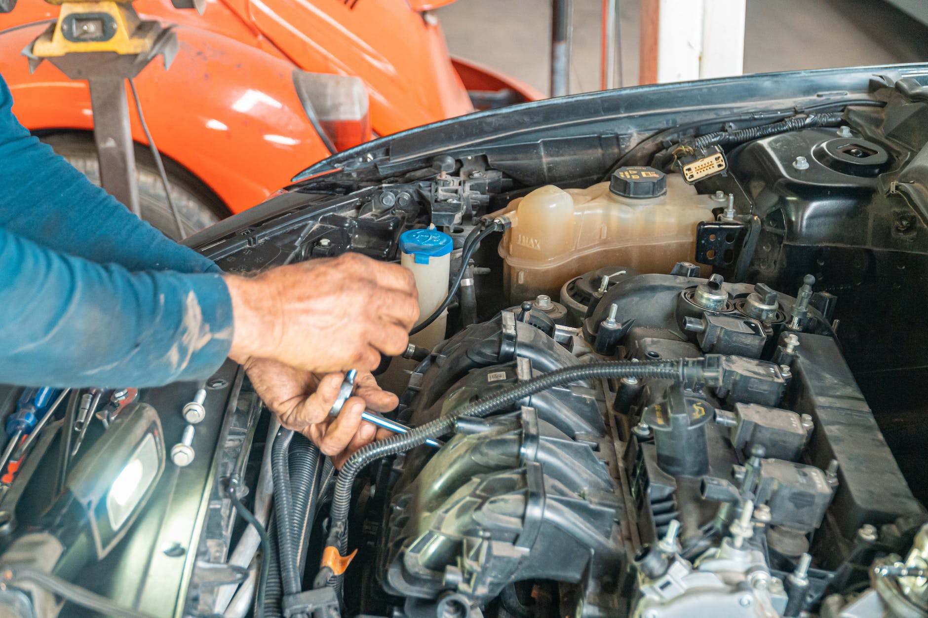 a person repairing car engine
